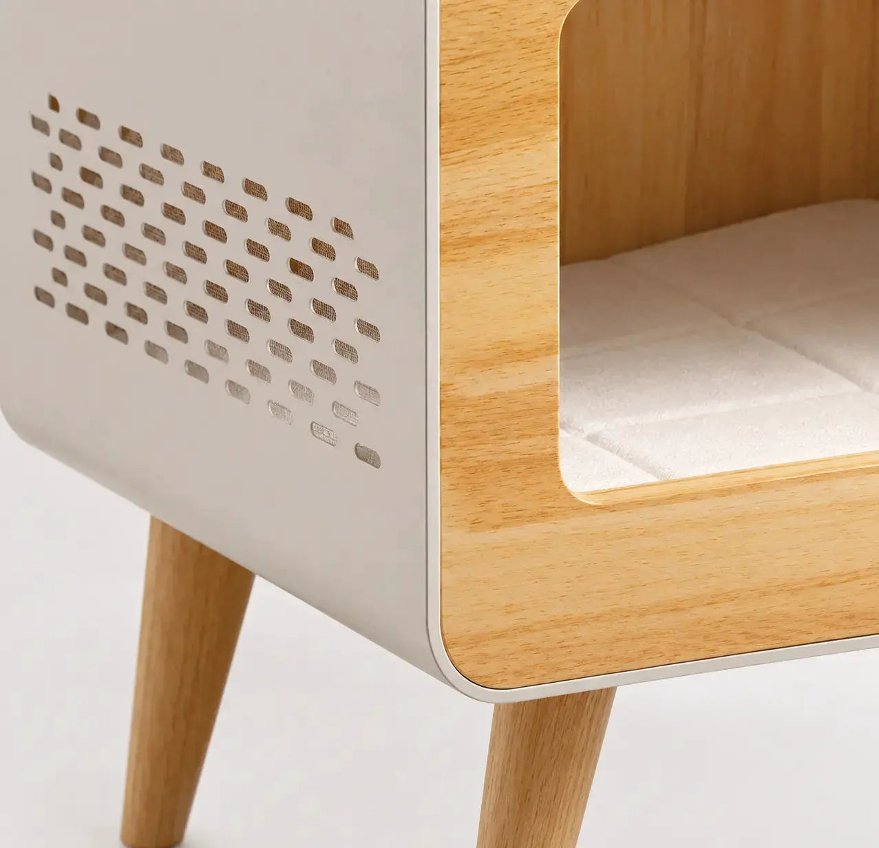 Detailfoto Nook nachtkast – ventilatieopeningen wit staal met houten paneel en zachte kussenbekleding